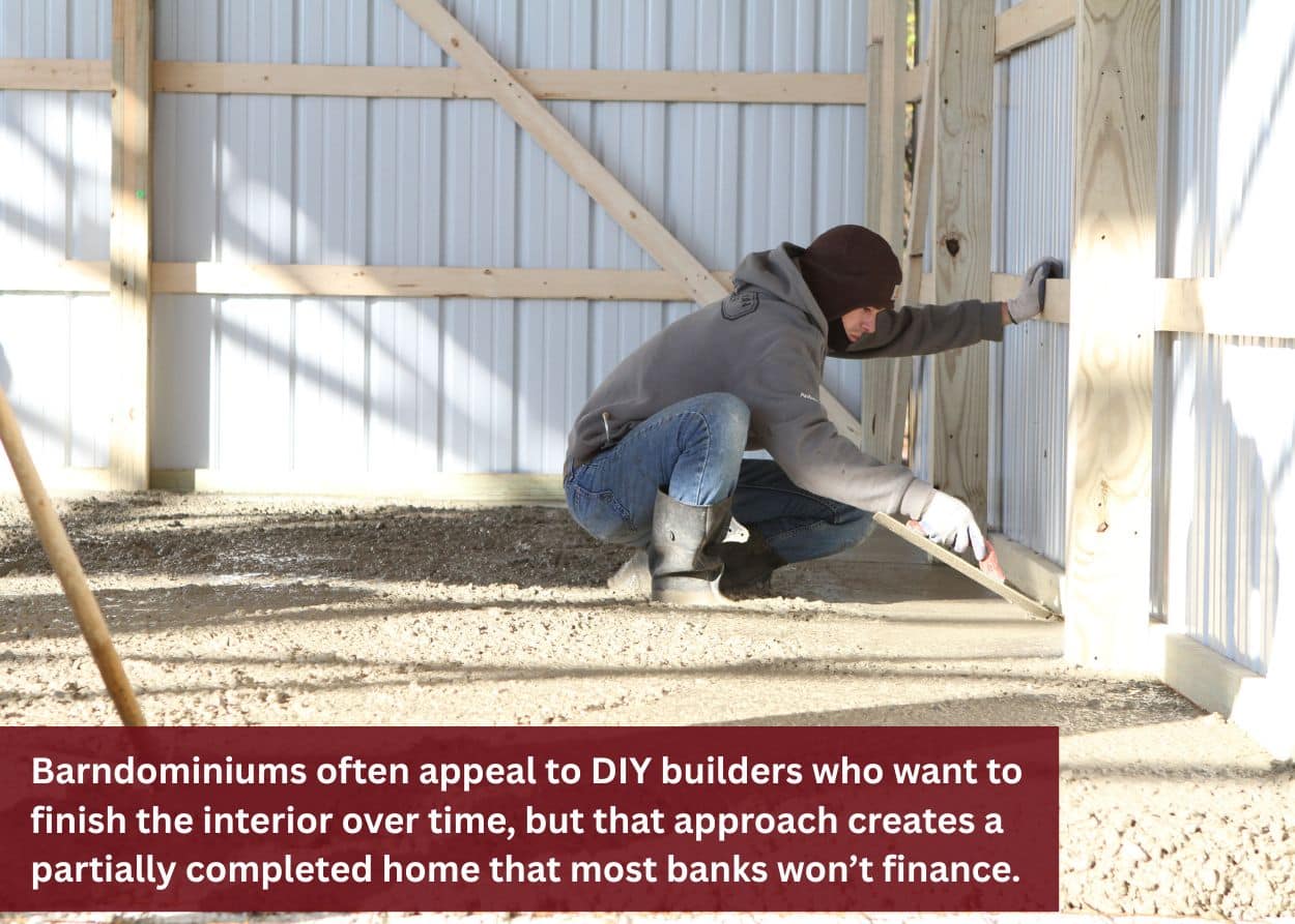 Person working on interior framing inside a post-frame building during construction.