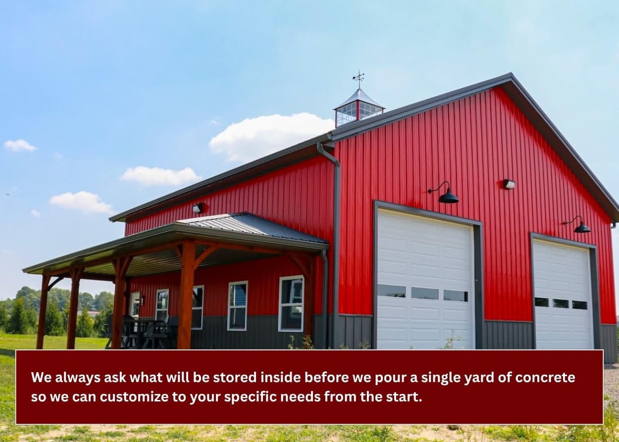 Custom red pole barn with large overhead doors and covered porch